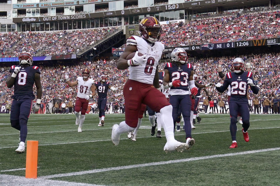 Washington Commanders running back Brian Robinson Jr. (8) enters the end zone for a touch down in front of New England Patriots linebacker Ja'Whaun Bentley (8), safety Kyle Dugger (23), and cornerback J.C. Jackson (29) in the first half of an NFL football game, Sunday, Nov. 5, 2023, in Foxborough, Mass. (AP Photo/Charles Krupa)