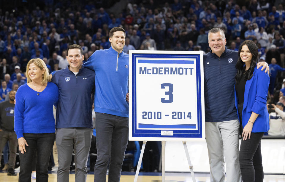 Former Creighton basketball player Doug McDermott, center, poses for photos with his family, from left, mother, Theresa; brother, Nick; father and Creighton coach Greg; and sister, Sydney, during a ceremony marking the retirement of his jersey number before an NCAA college basketball game between Creighton and Villanova on Wednesday, Dec. 20, 2023, in Omaha, Neb. (AP Photo/Rebecca S. Gratz)