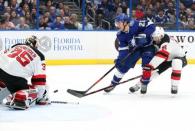 Nov 25, 2018; Tampa, FL, USA;Tampa Bay Lightning center Brayden Point (21) shoots the puck as New Jersey Devils goaltender Cory Schneider (35) defends during the first period at Amalie Arena. Mandatory Credit: Kim Klement-USA TODAY Sports
