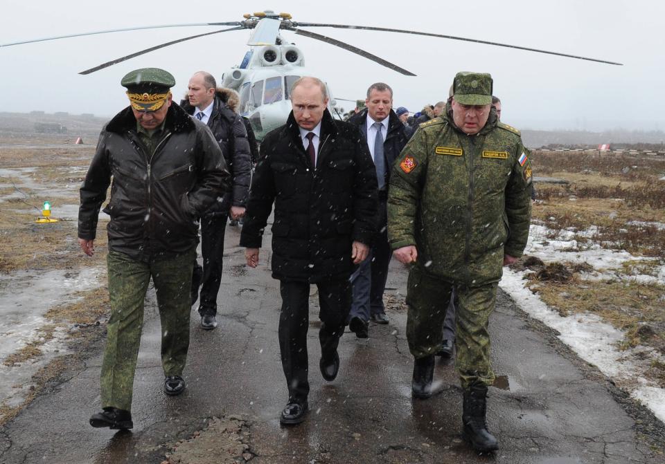 Russian President Vladimir Putin, center, and Defense Minister Sergei Shoigu, left, and the commander of the Western Military District Anatoly Sidorov, right, walk upon arrival to watch military exercise near St.Petersburg, Russia, Monday, March 3, 2014. Putin has sought and quickly got the Russian parliament's permission to use the Russian military in Ukraine.(AP Photo/RIA-Novosti, Mikhail Klimentyev, Presidential Press Service)