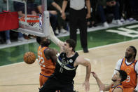 Milwaukee Bucks center Brook Lopez (11) slam dunks over Phoenix Suns center Deandre Ayton (22), guard Devin Booker and forward Jae Crowder, right, during the second half of Game 6 of basketball's NBA Finals Tuesday, July 20, 2021, in Milwaukee. (AP Photo/Aaron Gash)