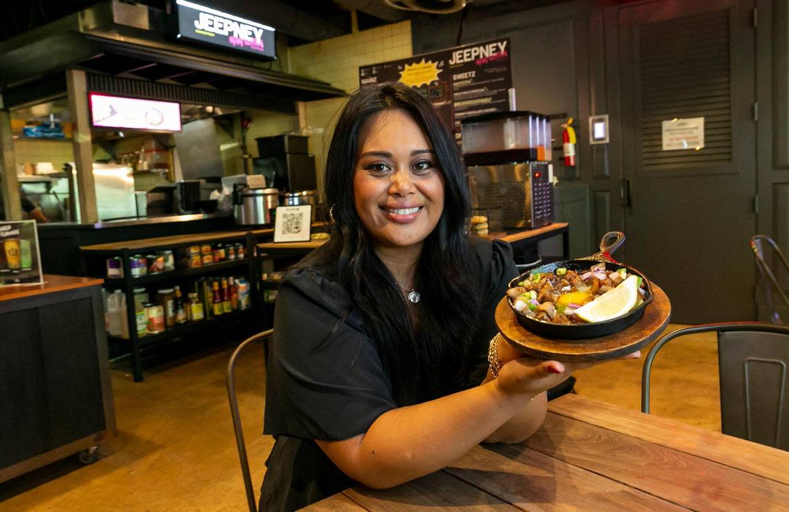 Nicole Ponseca shows off one of the specialties, pork sisig, at her Filipino restaurant Jeepney inside Miami’s 1-800-Lucky food hall. Ponseca opened the fast-casual version of her upscale New York restaurant in Wynwood to test the market.