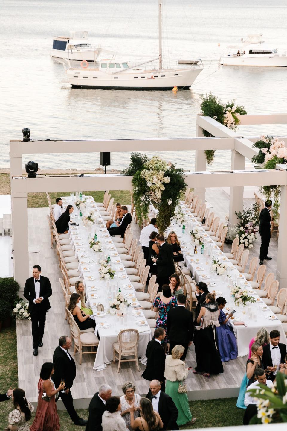 An outdoor wedding reception overlooking the water.