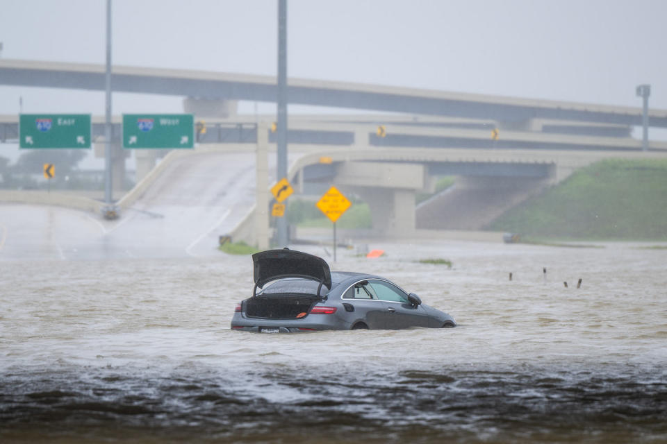 A vehicle is left abandoned in floodwater in Houston. (Brandon Bell / Getty Images)