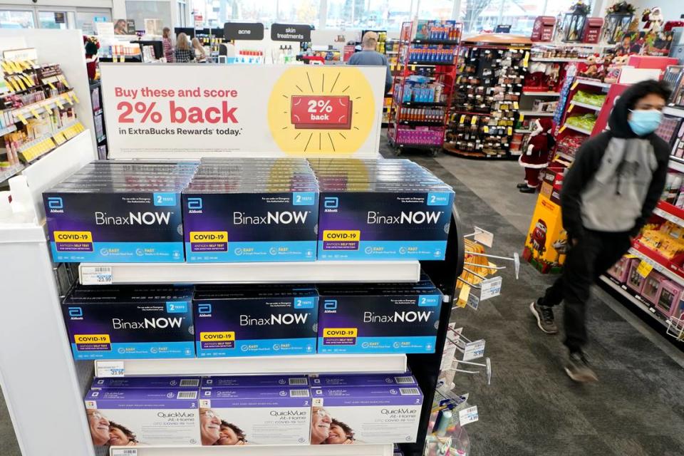 Boxes of BinaxNOW and QuickVue home COVID-19 tests are shown for sale Monday, Nov. 15, 2021, at a CVS store in Washington.