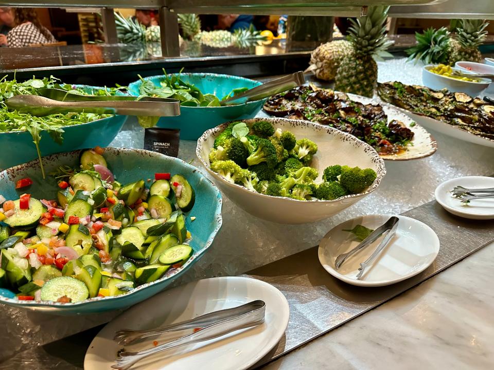 bowls of vegetables and salads at salad bar inside a fogo de chao