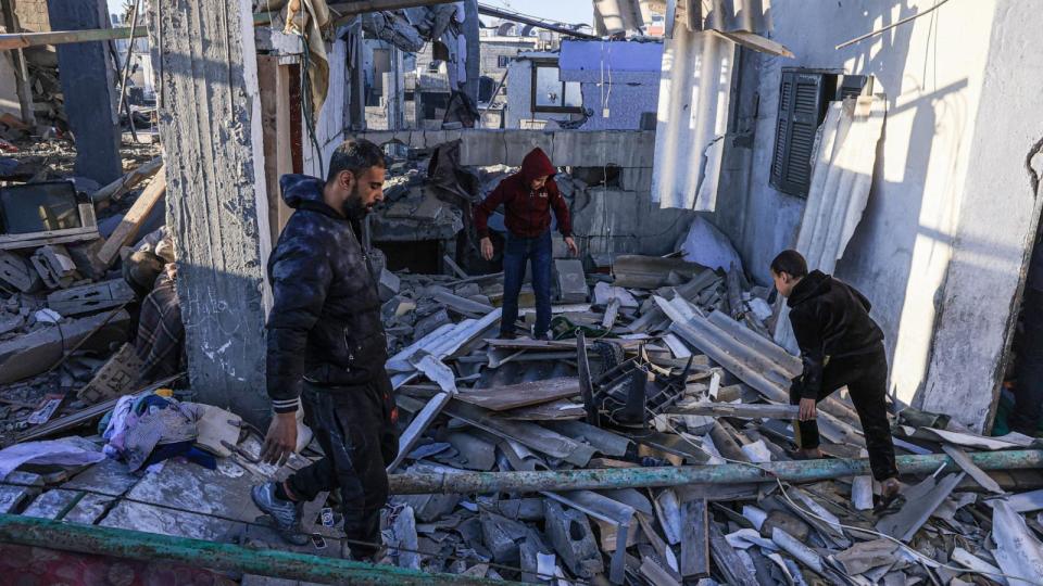 PHOTO: Palestinians search the rubble of a building following Israeli bombardment in Rafah in the southern Gaza Strip on Dec. 26, 2023, amid ongoing battles between Israel and the militant group Hamas.  (Said Khatib/AFP via Getty Images)