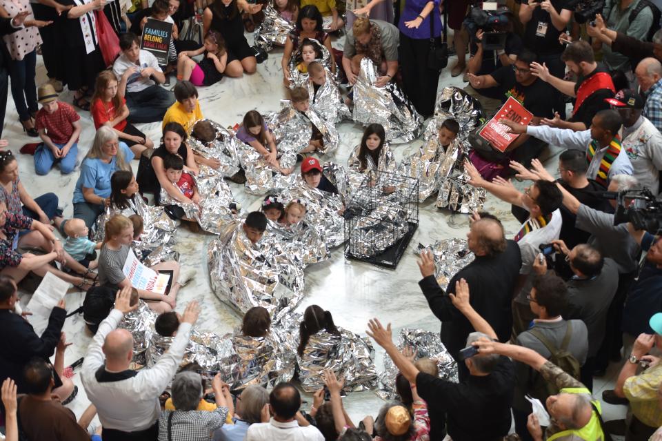 The Franciscan Action Network (FAN), Faith in Action, and the DMV Congregation Network hold a prayer vigil with children wrapped in survival blankets in the Russell Senate Office Building rotunda on June 21, 2018, in Washington, D.C. (Photo: Nicholas Kamm/AFP/Getty Images)