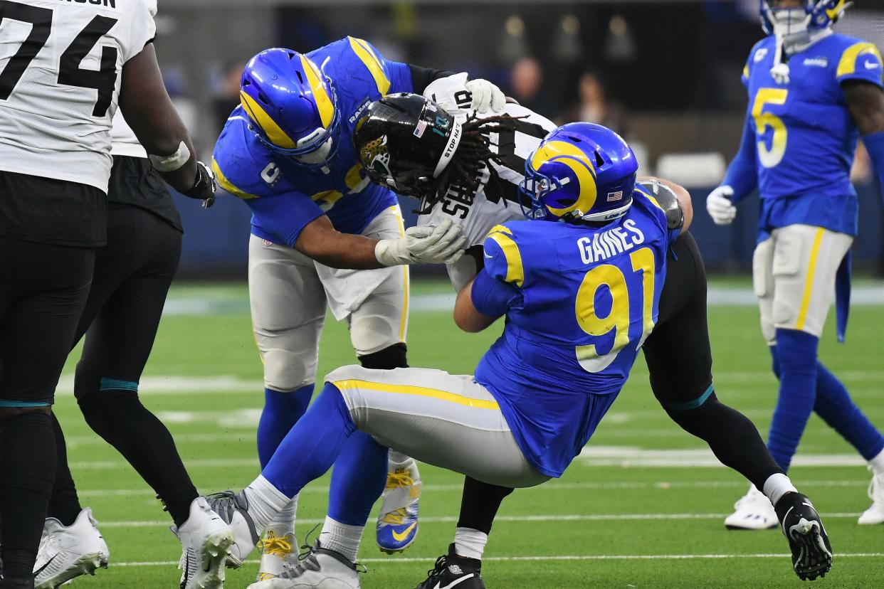 Rams defensive end Aaron Donald (99) and defensive end Greg Gaines (91) tackle Jaguars wide receiver Laviska Shenault Jr. (10) in the fourth quarter.