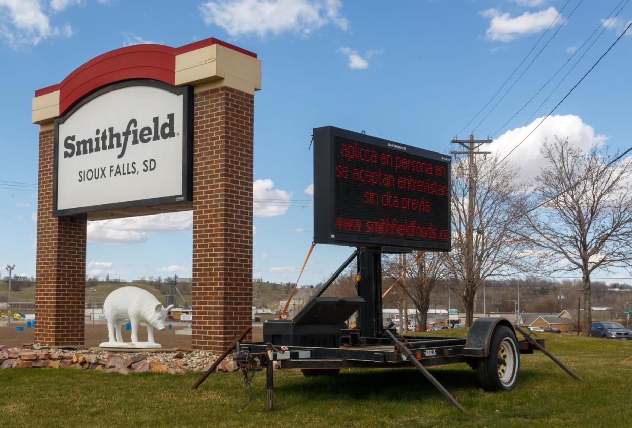 <span class="caption">Nearly 1,000 workers at this Smithfield Foods pork-processing plant in South Dakota contracted COVID-19 between mid-March and mid-April 2020. </span> <span class="attribution"><a class="link " href="https://www.gettyimages.com/detail/news-photo/sign-for-the-smithfield-foods-pork-processing-plant-in-news-photo/1210647867?adppopup=true" rel="nofollow noopener" target="_blank" data-ylk="slk:Kerem Yucel / AFP via Getty Images;elm:context_link;itc:0;sec:content-canvas">Kerem Yucel / AFP via Getty Images</a></span>