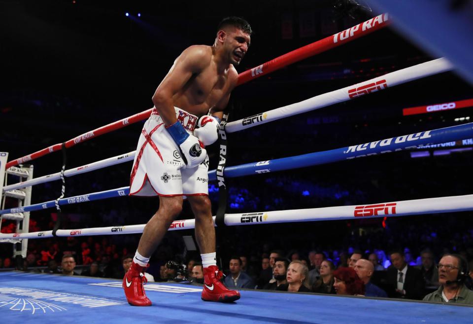 Khan was unable to continue after the sixth round low blow. (Action Images via Reuters)