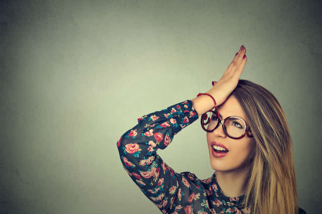 Regrets wrong doing. Closeup portrait silly young woman, slapping hand on head having duh moment isolated on gray background. Ne