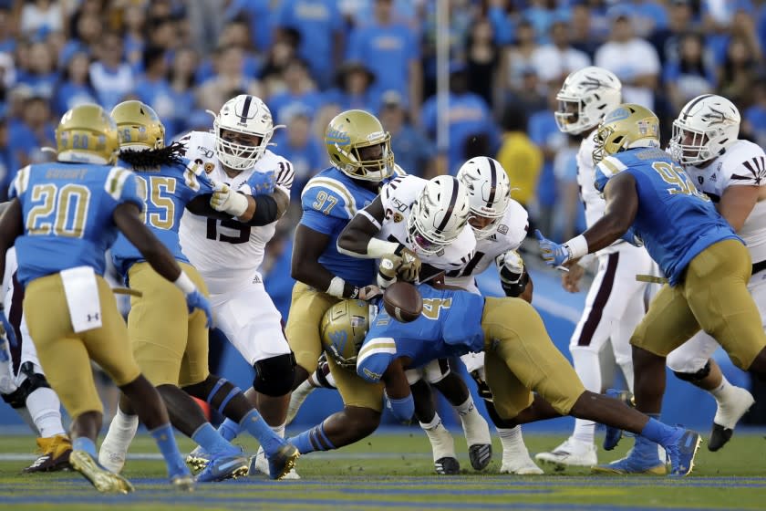 Bruins defensive back Stephan Blaylock forces Arizona State running back Eno Benjamin to fumble on the first drive of their game on Oct. 26, 2019.