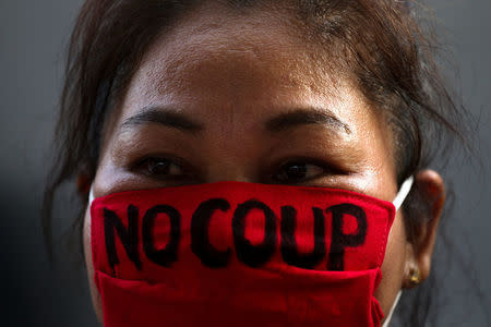 A pro-democracy protester wearing the face mask with a written message, takes part in a protest against junta delaying polls in Bangkok, Thailand January 27, 2018. REUTERS/Athit Perawongmetha