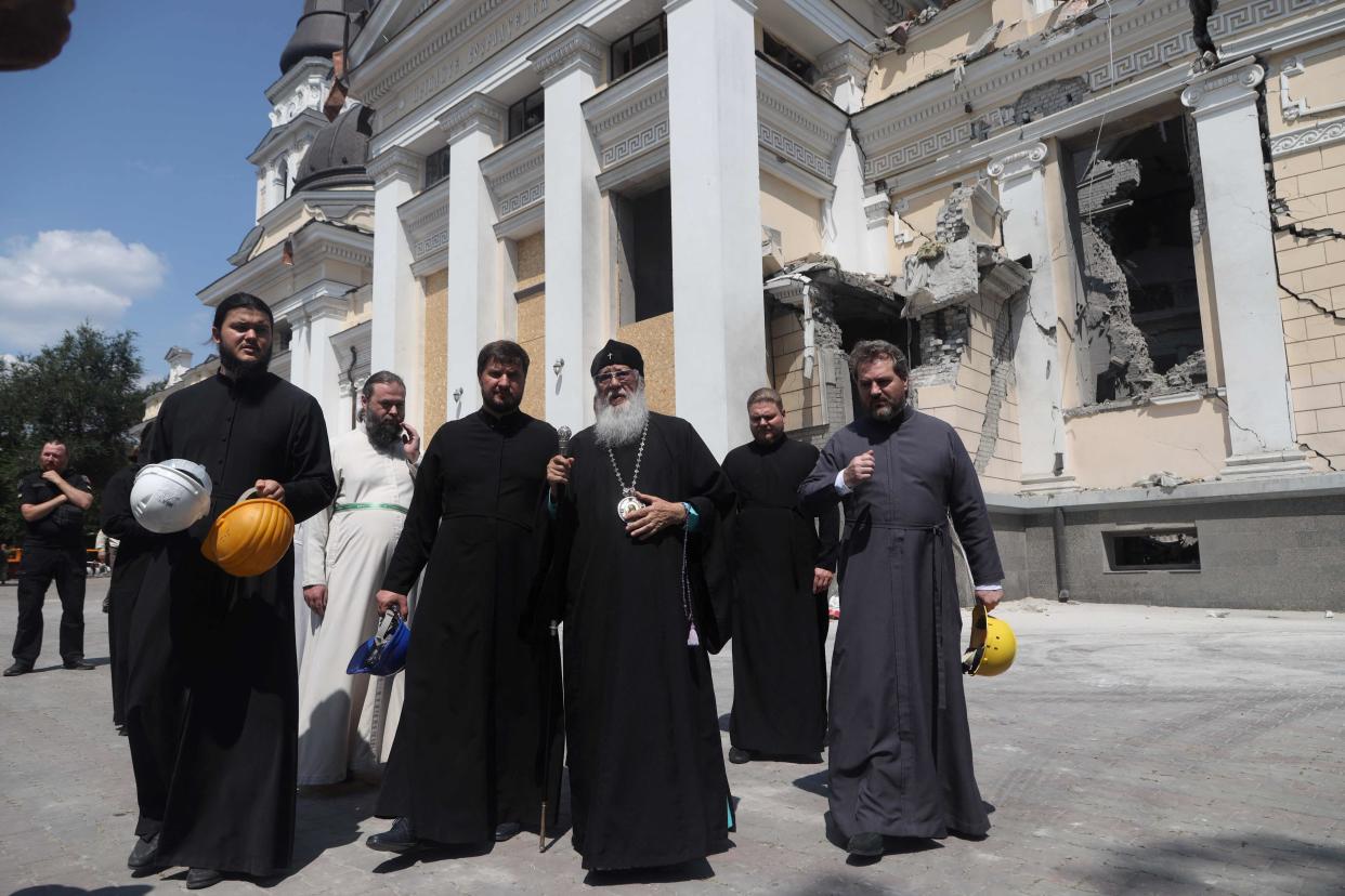 Priests examine the destructions as they walk outside the Transfiguration Cathedral damaged as a result of a missile strike in Odesa (AFP via Getty Images)