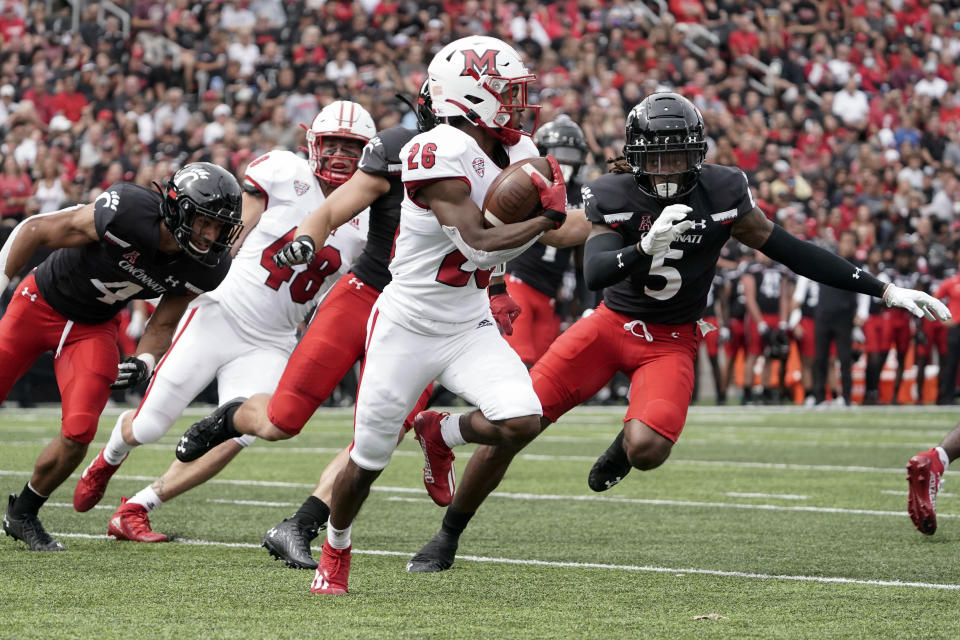 Miami (Ohio) running back Kevin Davis (26) runs during the first half of an NCAA college football game against Cincinnati, Saturday, Sept. 4, 2021, in Cincinnati. (AP Photo/Jeff Dean)