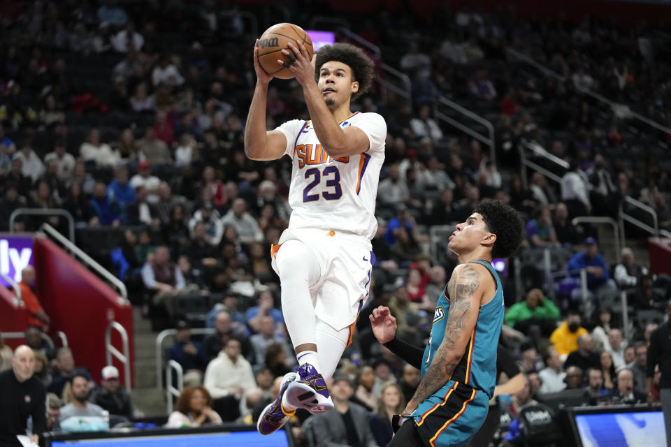 Phoenix Suns forward Cameron Johnson (23) drives on Detroit Pistons guard Killian Hayes (7) in the first half of an NBA basketball game in Detroit, Saturday, Feb. 4, 2023. (AP Photo/Paul Sancya)