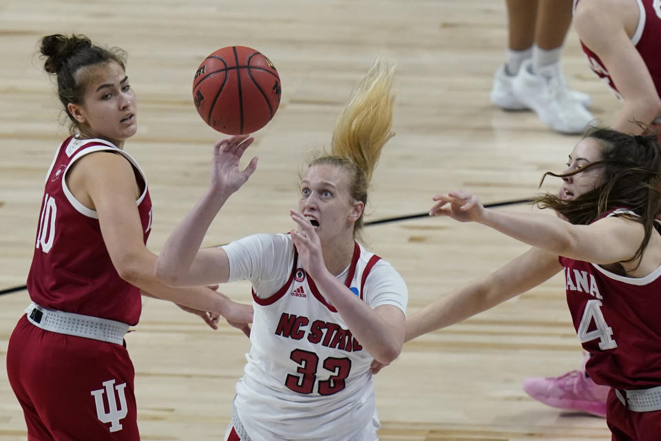 North Carolina State center Elissa Cunane (33) is pressured by Indiana forward Mackenzie Holmes, right, and Indiana forward Aleksa Gulbe (10) during the first half of a college basketball game in the Sweet Sixteen round of the women's NCAA tournament at the Alamodome in San Antonio, Saturday, March 27, 2021. (AP Photo/Eric Gay)