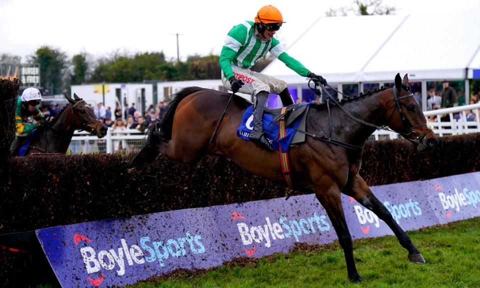 <span>Macdermott and jockey Danny Mullins jump a fence on the way to victory at the Scottish Grand National.</span><span>Photograph: Niall Carson/PA</span>