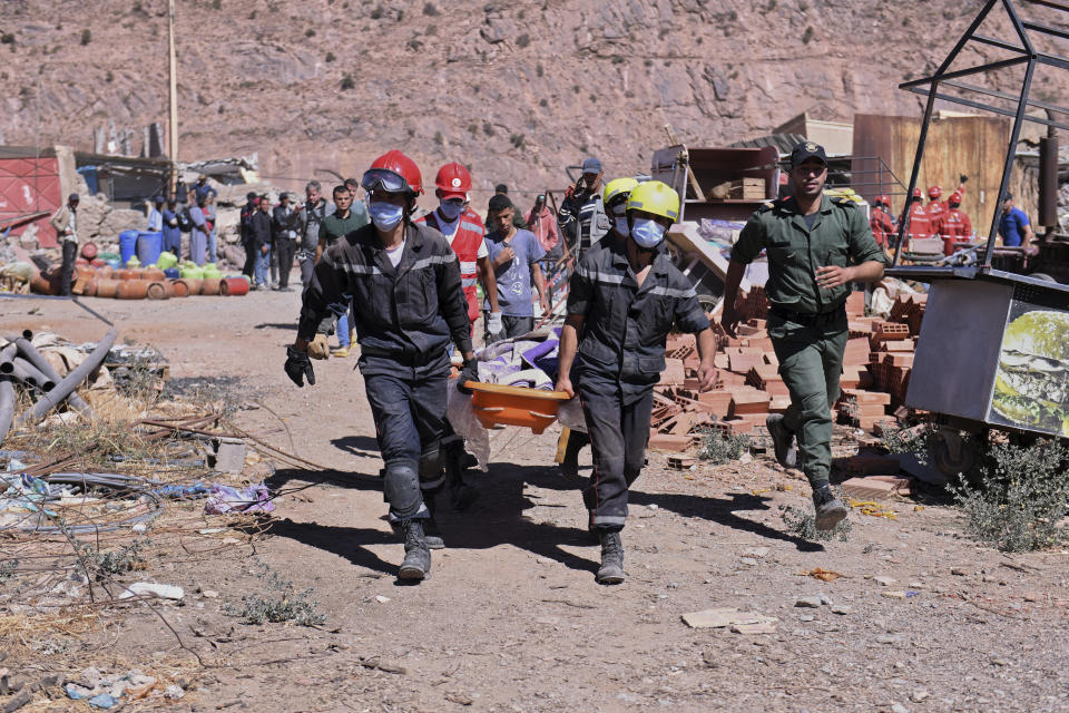 A victim is carried away by rescue workers in Talat N'yakoub, Morocco, Monday Sept. 11, 2023. More than 2,000 people were killed, and the toll was expected to rise as rescuers struggled to reach hard-hit remote areas after a powerful earthquake struck Morocco. (Fernando Sanchez/Europa Press via AP)