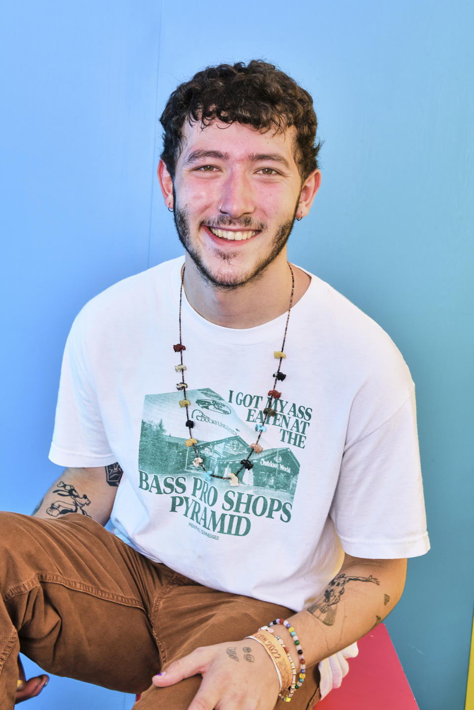 Close-up of Frankie smiling and wearing an "I Got My Ass Eaten at the Bass Pro Shops Pyramid" T-shirt