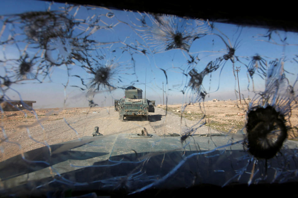 <p>Iraqi rapid response forces advancing south of Mosul are seen through a shattered glass window of a military vehicle, in Iraq, Feb. 20, 2017. (Alaa Al-Marjani/Reuters) </p>