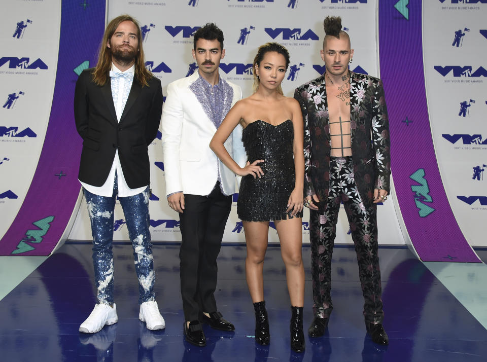 <p>DNCE coordinated their looks (and Joe Jonas showed off a new mustache). (Photo: AP) </p>