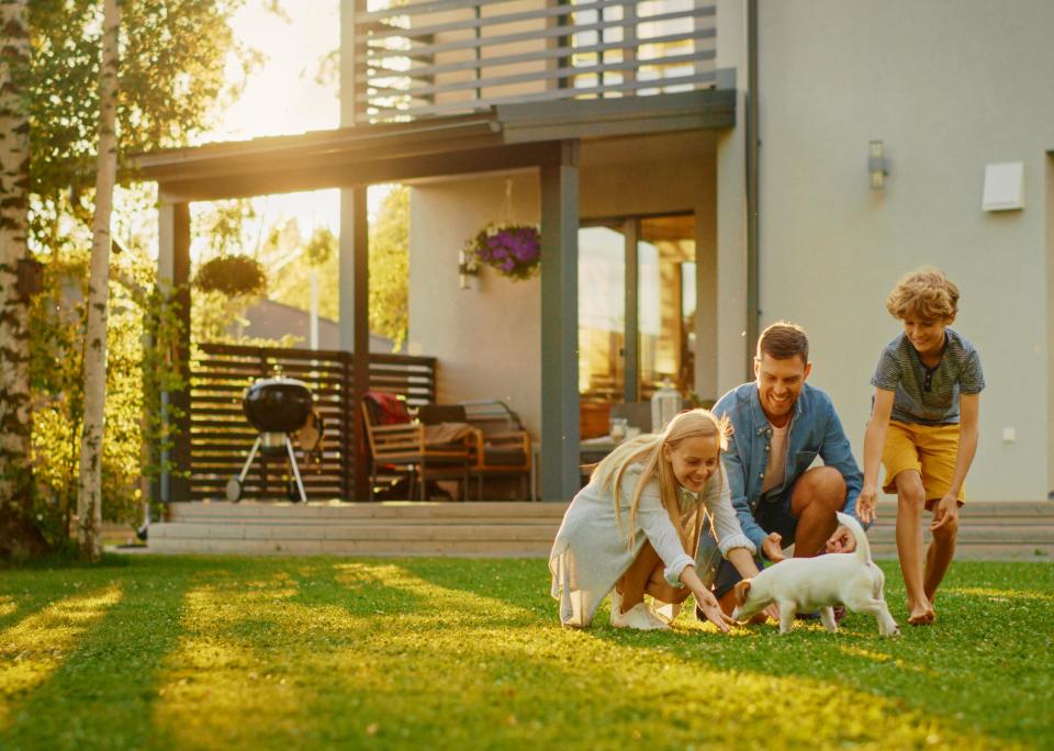 Happy family in backyard with dog.