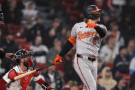 Baltimore Orioles' Gunnar Henderson, right, watches the flight of his two-run home run in the 10th inning of a baseball game against the Boston Red Sox, Thursday, April 11, 2024, in Boston. (AP Photo/Charles Krupa)