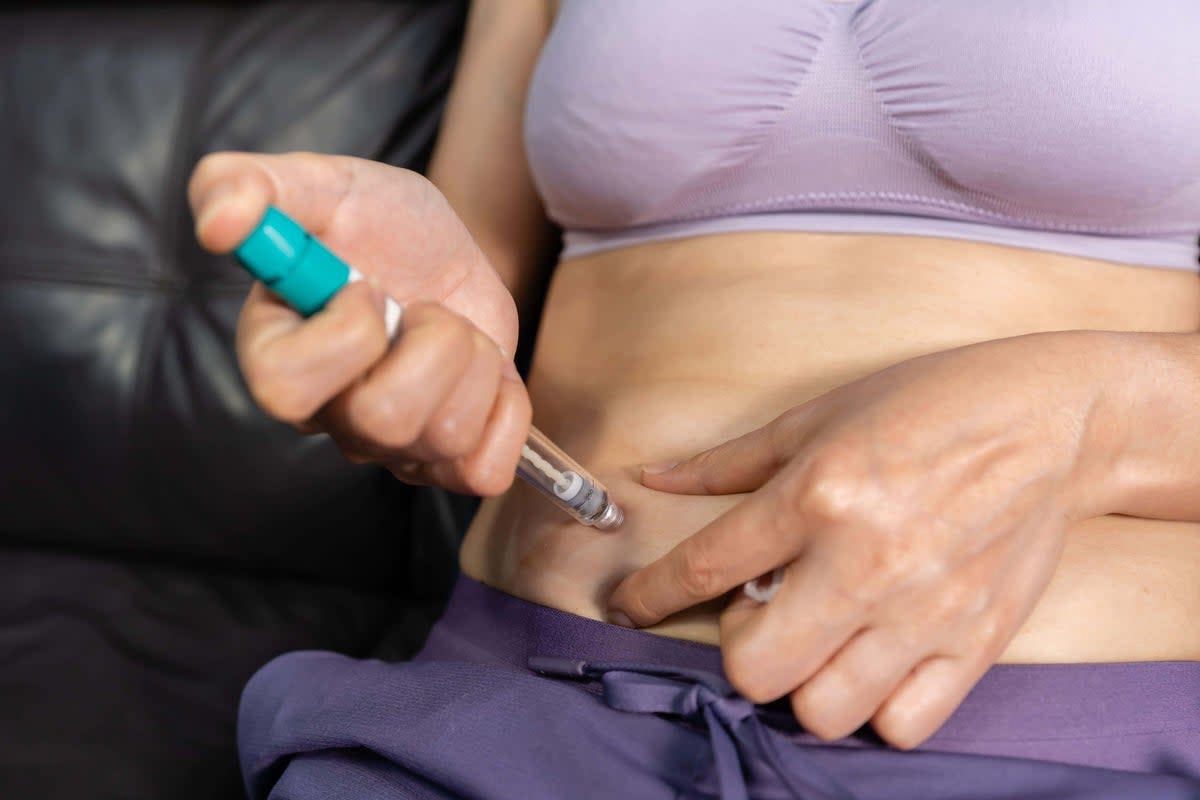 Woman uses a prescription drug that is said to help with weight loss (Alamy/PA) (PA )