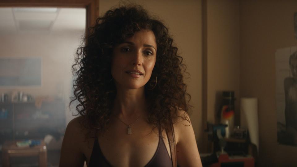 Rose Byrne with big curly hair wearing a leotard on Apple TV's Physical