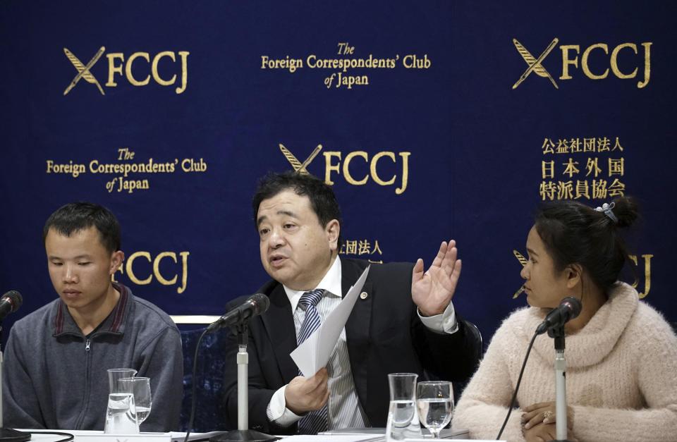 In this Nov. 28, 2018, photo, lawyer Shoichi Ibusuki, center, speaks during a press conference in Tokyo, on the problems in Japan's technical intern program, with Eng Pisey, right, Cambodian technical trainee and Huang Shihu, left, Chinese technical trainee in Tokyo. Ibusuki, lawyer specializing in labor cases and supporting victimized foreign students and interns, called the internship program as a disguise to use trainees as mere cheap labor and should be scrapped and replaced with the new program underway. Japan is set to approve legislation that would officially open the door to foreign workers to do unskilled jobs and possibly eventually become citizens. Lawmakers were due to vote Friday, Dec. 7, on a government proposal to allow hundreds of thousands of foreign laborers to live and work in a country that has long resisted accepting outsiders. (AP Photo/Eugene Hoshiko)