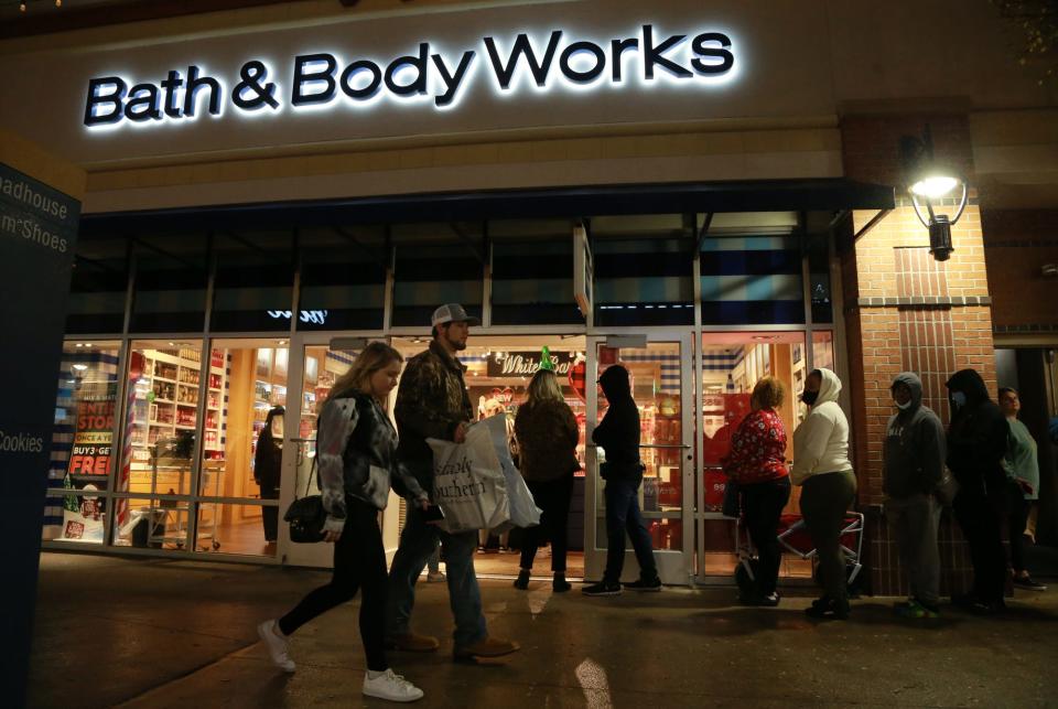 Black Friday shoppers wait in line at Bath & Body Works Friday morning at Tanger Outlets in Pooler.
