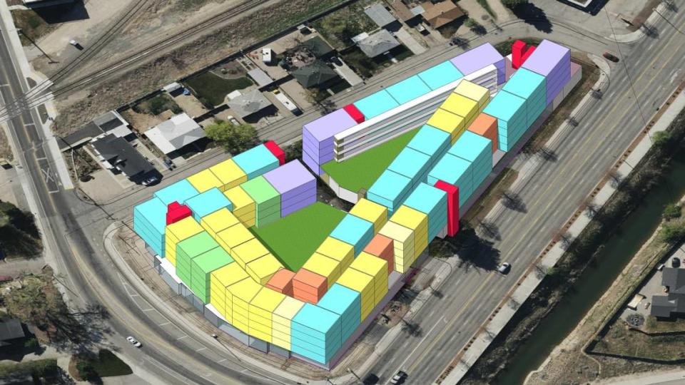 This aerial rendering looking west shows the proposed building with unit-type split up by color. Orange represents studio apartments; cyan for two-bedroom, two-bath; purple for three-bedroom, two-bath. All other colors represent one-bedroom, one bath units with various designs.