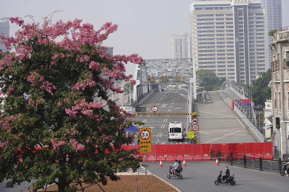 Barriers form a security checkpoint in the Haizhu district in Guangzhou in southern China's Guangdong province, Friday, Nov. 11, 2022. As the country reported 10,729 new COVID cases on Friday, more than 5 million people were under lockdown in the southern manufacturing hub Guangzhou and the western megacity Chongqing. (AP Photo)