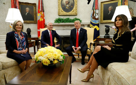 U.S. President Donald Trump meets with Australian Prime Minister Malcolm Turnbull as Turnbull's wife Lucy and U.S. first lady Melania Trump sit beside them in the Oval Office of the White House in Washington, U.S., February 23, 2018. REUTERS/Kevin Lamarque