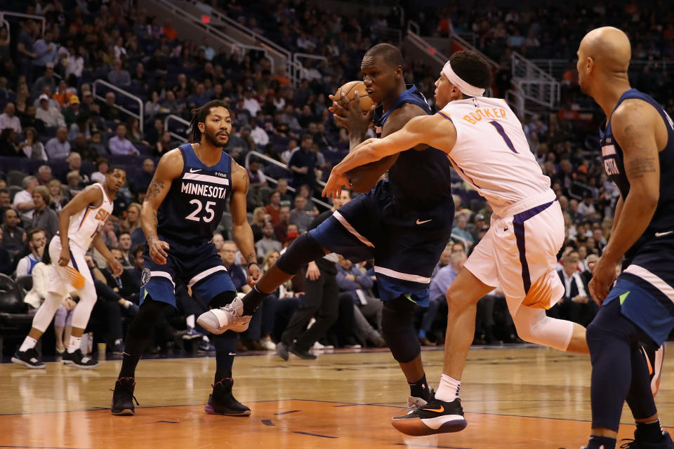 Devin Booker (1) and Gorgui Dieng tried their best to take their on-court beef to the tunnel before security intervened. (Getty)