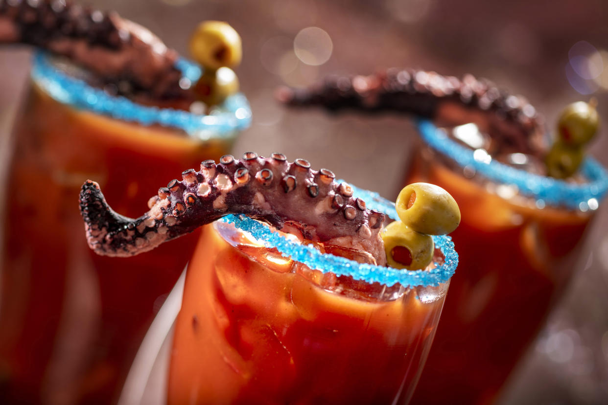 It's a Squid's Revenge! This michelada is rimmed with blue salt and garnished with a charred octopus tentacle. (Photo: Walt Disney World Resort)