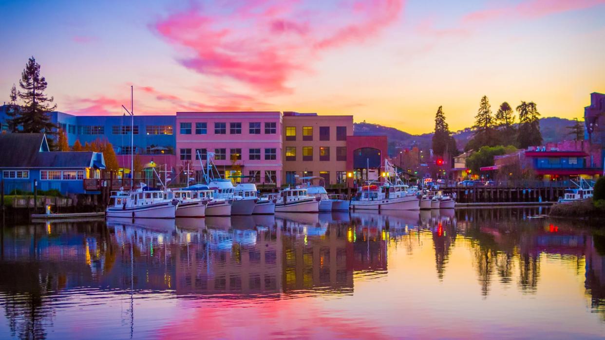 Yachts berth in the Petaluma River turning basin under an autumn sunset.