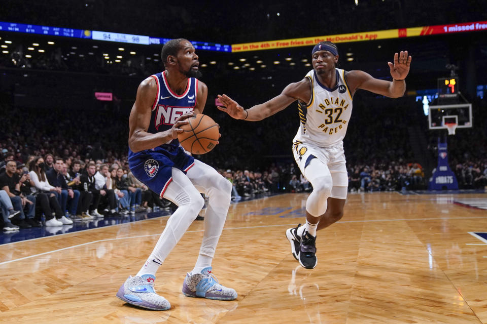 Brooklyn Nets' Kevin Durant, left, looks for a shot past Indiana Pacers' Terry Taylor during the second half of an NBA basketball game at the Barclays Center, Sunday, Apr. 10, 2022, in New York. The Nets defeated the Pacers 134-126. (AP Photo/Seth Wenig)