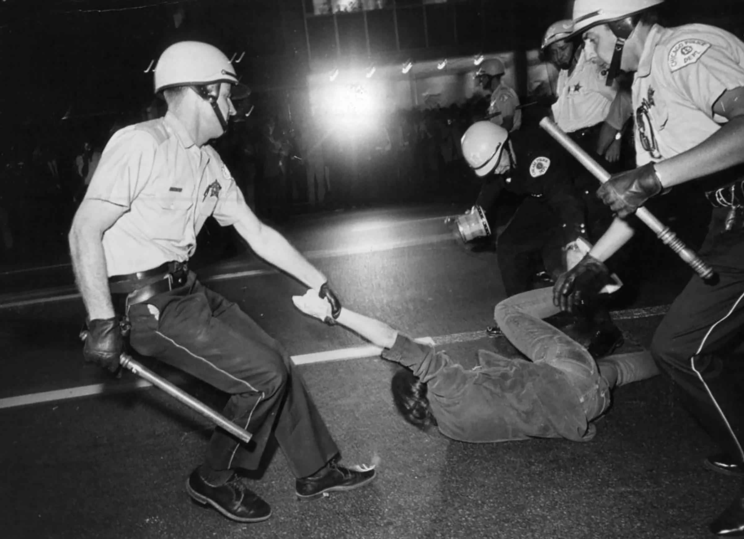 The police detain a demonstrator in front of the Conrad Hilton during the 1968 Democratic National Convention in Chicago, Aug. 29, 1968. (Barton Silverman/The New York Times)