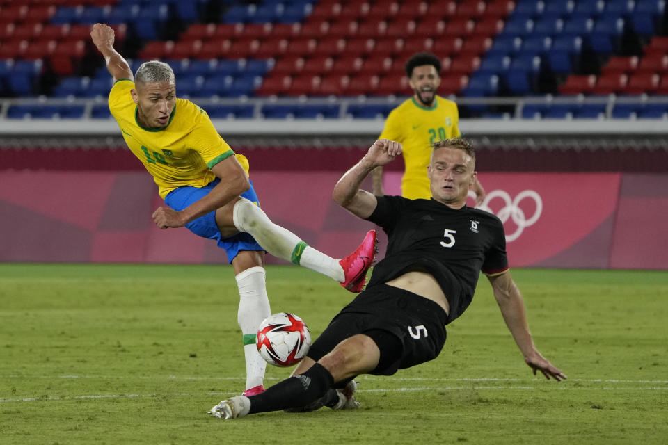 Germany's Amos Pieper blocks Brazil's Richarlison during a men's soccer match at the 2020 Summer Olympics, Thursday, July 22, 2021, in Yokohama, Japan. (AP Photo/Kiichiro Sato)