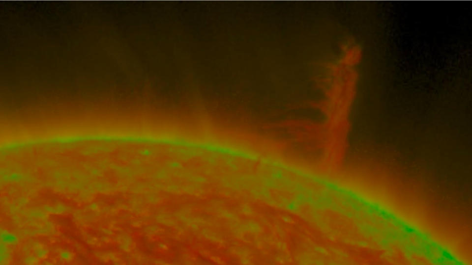 A still image of the solar tornado rising above the sun.