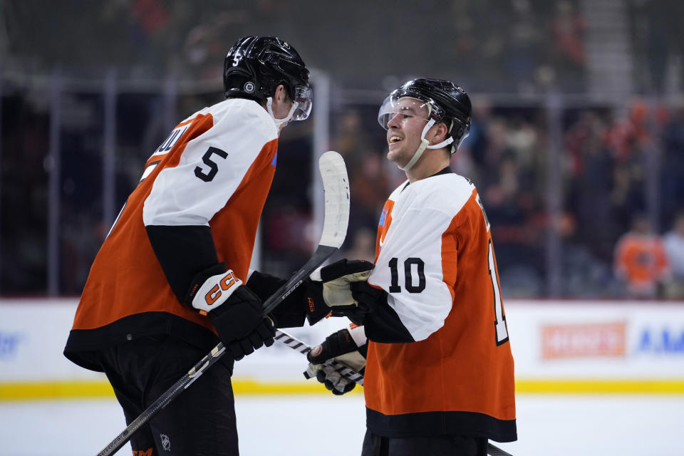 Philadelphia Flyers' Bobby Brink, right, and Egor Zamula celebrate after the Flyers won an NHL hockey game against the Minnesota Wild, Thursday, Oct. 26, 2023, in Philadelphia. (AP Photo/Matt Slocum)