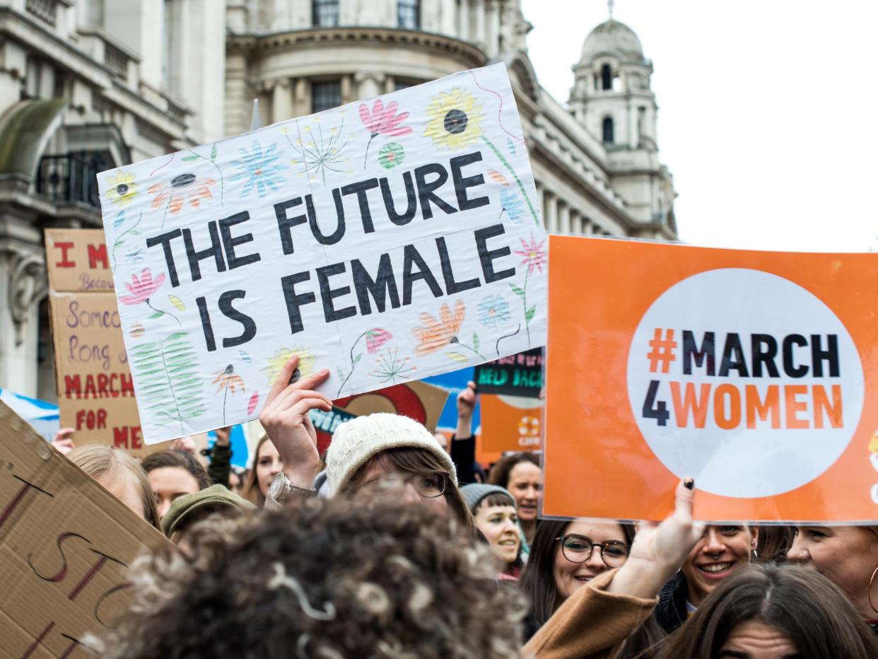 Placards are displayed during the March4Women on 4 March in London: Getty