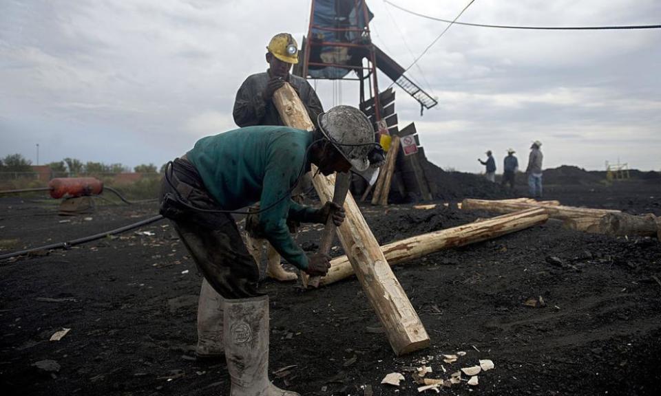 Miners make wooden support beams in a coal mine in Agujita, Coahuila state, on 13 November 2012.