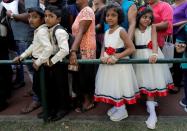 Twins wait in the line to register their names during an event to attempt to break the world record for the biggest gathering of twins in Colombo