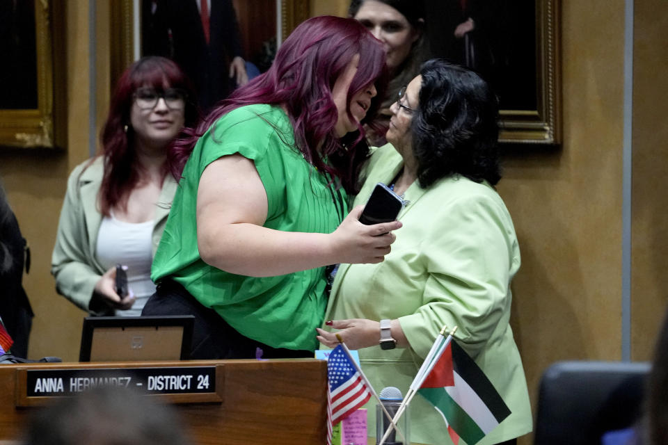 Democratic Arizona state senator Anna Hernandez, D-District 24, left, hugs a colleague after a their vote, Wednesday, May 1, 2024, at the Capitol in Phoenix. Democrats secured enough votes in the Arizona Senate to repeal a Civil War-era ban on abortions that the state's highest court recently allowed to take effect. (AP Photo/Matt York)