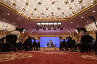 Journalists attend a news conference by Zhang Yesui, a spokesman for the National People's Congress, broadcast remotely to the media center on the eve of the annual legislature opening session in Beijing on Thursday, May 21, 2020. China's ceremonial parliament will consider legislation that could limit opposition activity in Hong Kong, a spokesperson said Thursday, appearing to confirm speculation that China will sidestep the territory's own legislative body in enacting legislation to crack down on activity Beijing considers subversive. (AP Photo/Mark Schiefelbein, Pool)