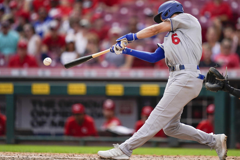 Los Angeles Dodgers' Trea Turner (6) hits a base hit during the ninth inning of a baseball game against the Cincinnati Reds in Cincinnati, Sunday, Sept 19, 2021. (AP Photo/Bryan Woolston)